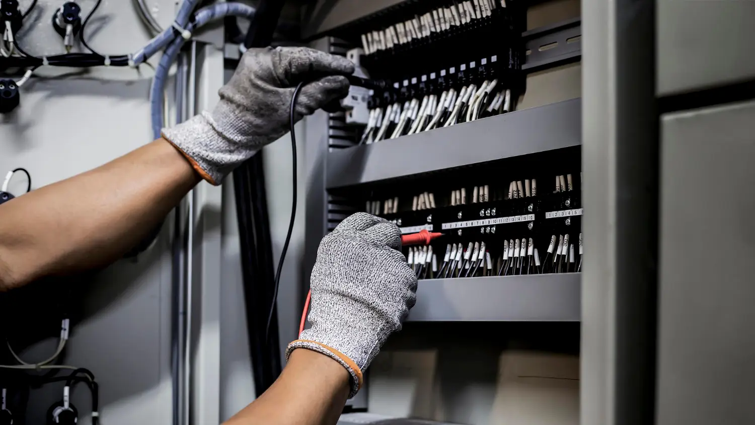 Electrician examining a large electrical switchboard
